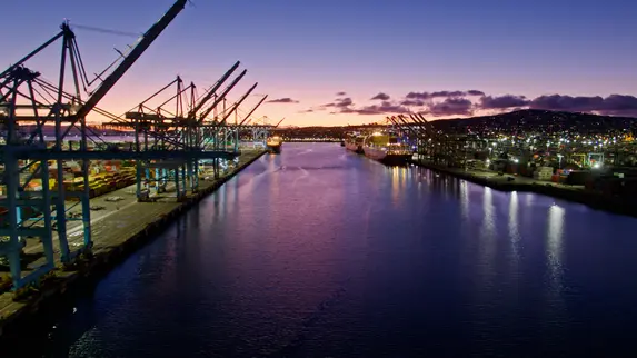 shipping boats at dock with sunset background