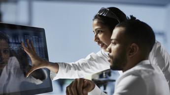 Scientists Working on Computer In Modern Laboratory 