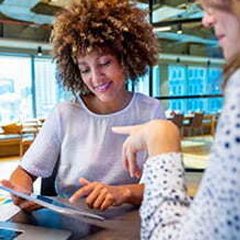 Two women looking at a digital tablet