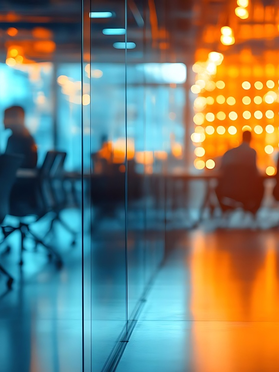 Blurred Photo of Busy Office Meeting Room with Orange and Blue Lighting