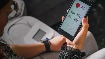 woman monitoring here blood pressure in an App