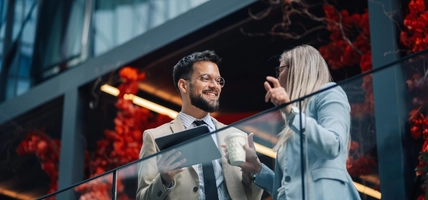 Business colleagues discussing work on office balcony