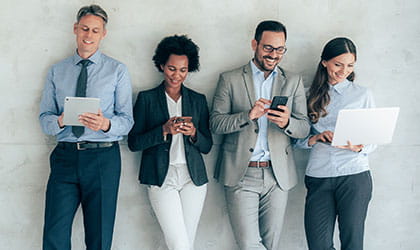 four people looking at their mobile devices