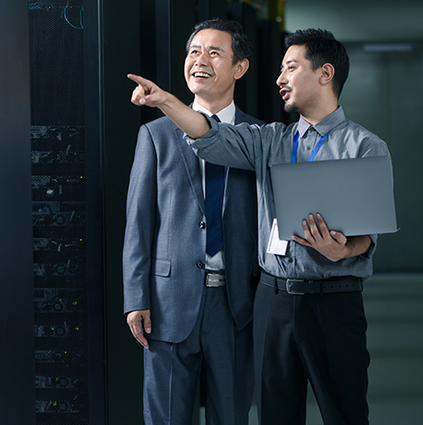 men with laptop in a hand showing data center to his senior