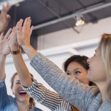 Cheerful women Giving High Five