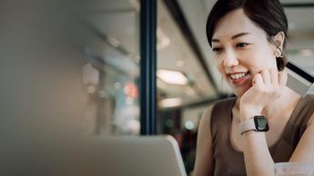 woman working on laptop while having meal