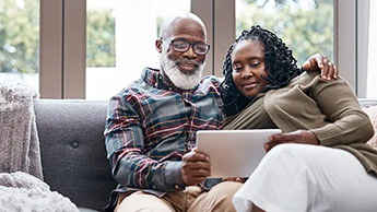 A couple searching the internet on a tablet PC