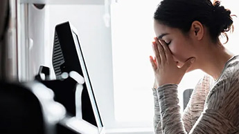 Anxious woman at computer