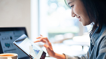 Woman with tablet and notebook PC