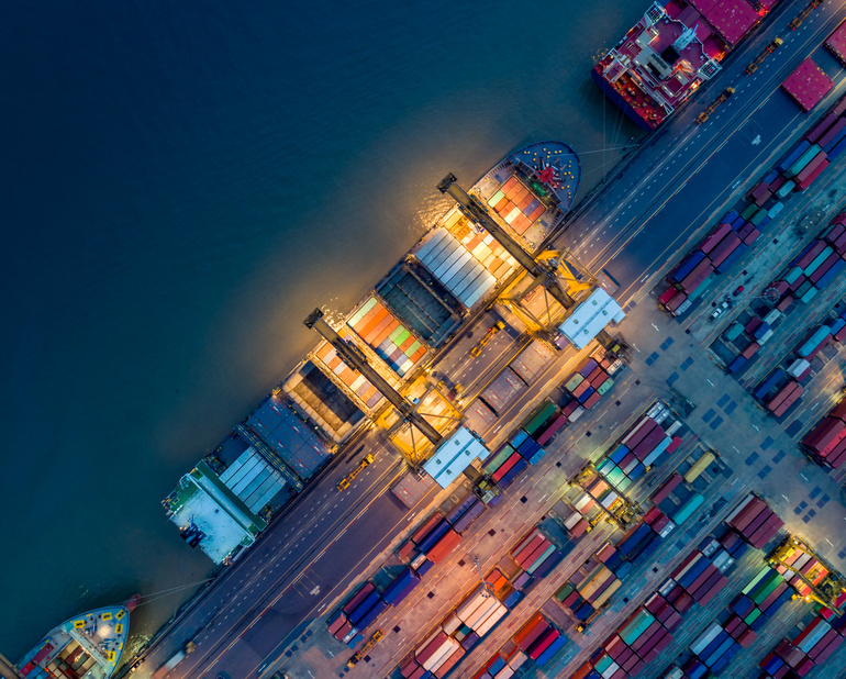 Logistics and transportation of Container Cargo ship and Cargo plane with working crane bridge in shipyard at sunrise, logistic import export and transport industry background