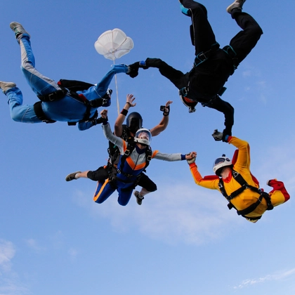 Group of skydivers is in the sky