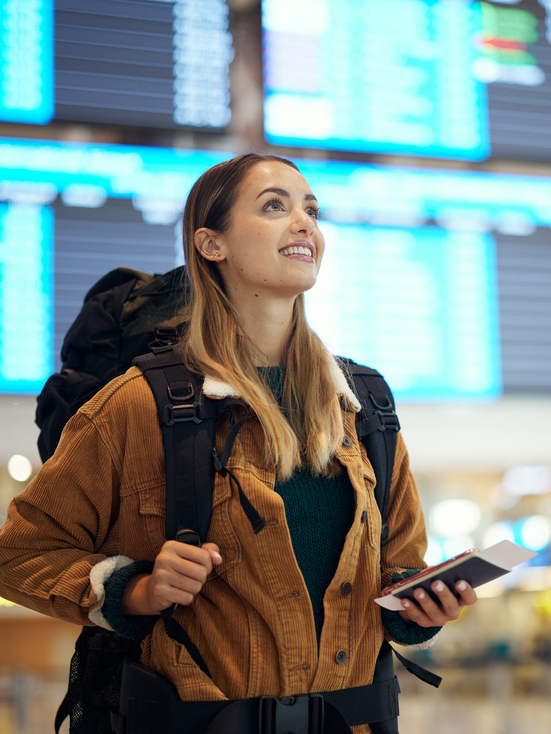 Travel, airport and excited woman with passport. travel ticket and documents for immigration, journey and flight schedule. Backpack person with identity document search for international registration