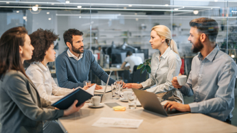 Young business colleagues communicating on a meeting in the office