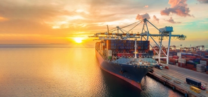 crane loading cargo container to container ship 