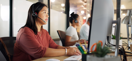 call center - woman on headset at computer
