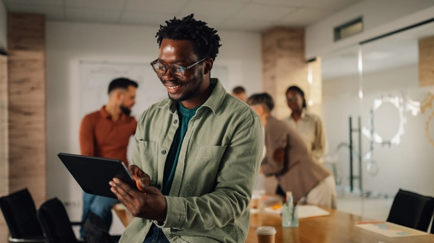 man reviewing tablet in office setting