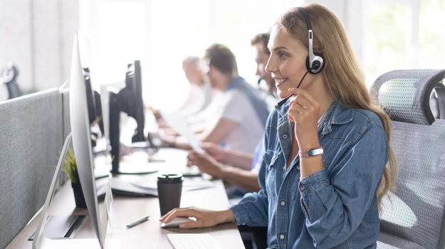 woman happily talking on headset in call center
