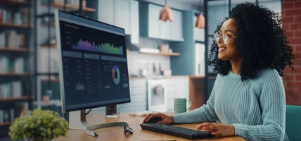 woman working at home looking at data on screen