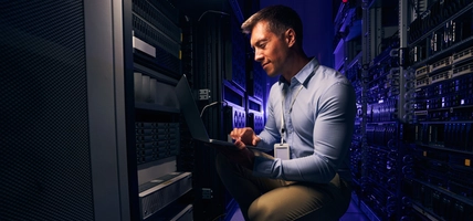 Employee checking hardware equipment in server room