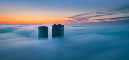 two buildings above clouds