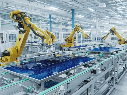 Large Production Line with Industrial Robot Arms at Modern Bright Factory. Solar Panels are being Assembled on Conveyor. Automated Manufacturing Facility