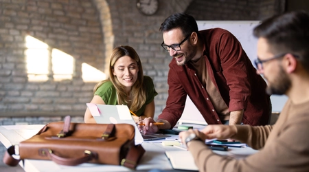happy colleagues meeting at a table