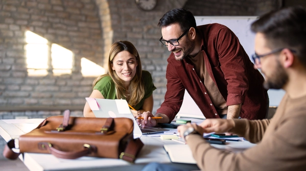 happy colleagues meeting at a table