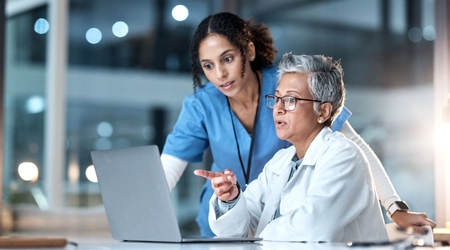 healthcare colleagues reviewing laptop screen