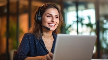 woman wearing headset sitting in front of laptop