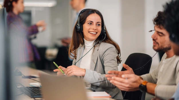 woman smiling while wearing headset at work