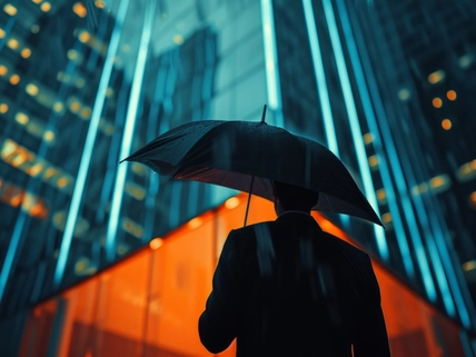 Businessman under an umbrella during the rain, abstract insurance concept. Background with selective focus