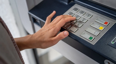 hand using banking machine