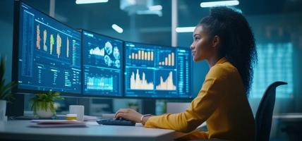 woman working at multiple screens of data