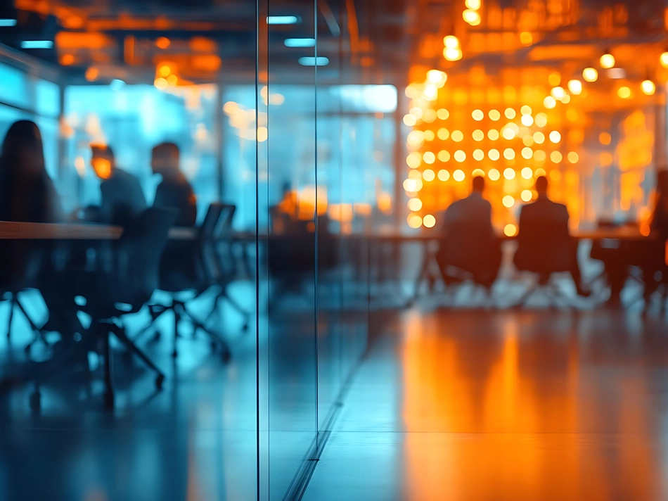 Blurred Photo of Busy Office Meeting Room with Orange and Blue Lighting