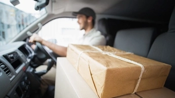 man is driving with package 