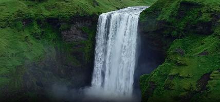 Slow motion aerial view of magnificent famous waterfall Skogafoss in Iceland