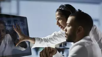 Scientists Working on Computer In Modern Laboratory