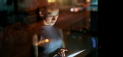 woman looking at tablet