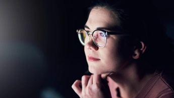 businesswoman using a computer during a late night at work