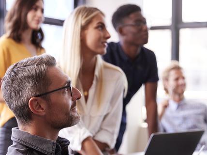 Creative business team listening at a brainstorm meeting, close up, vertical