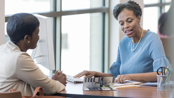Loan officer reviews woman's loan application