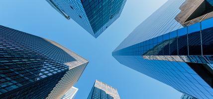 looking up at buildings with blue sky behind them