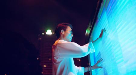 Young businessman using touch screen on the street