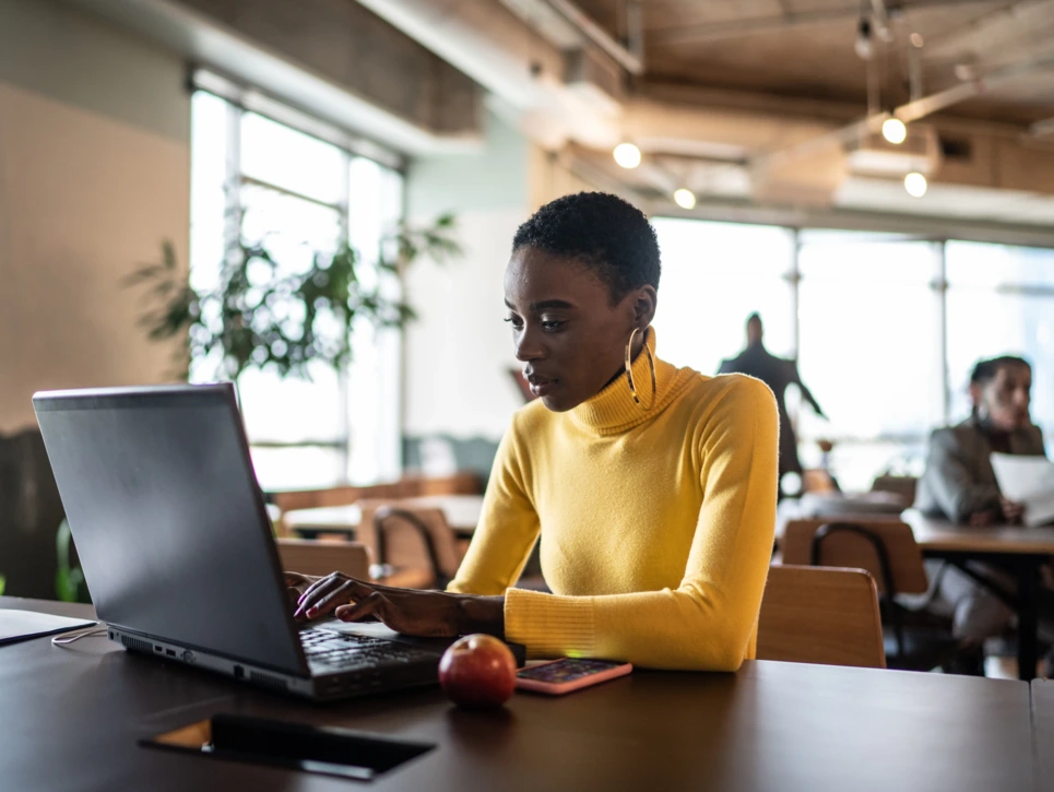 Young businesswoman working with laptop at coworking