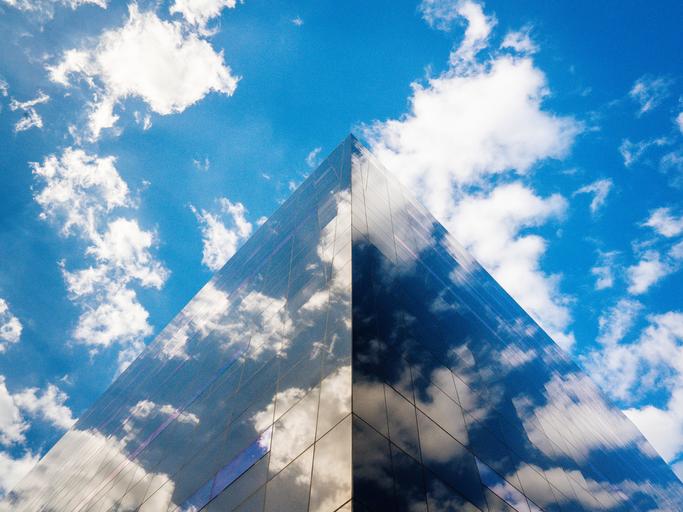 Building against bright blue sky filled with clouds