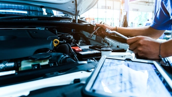 man working on car battery