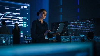 She is holding laptop in her workplace