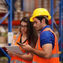 two warehouse employees working together