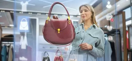 woman shopping on virtual wall for red handbag