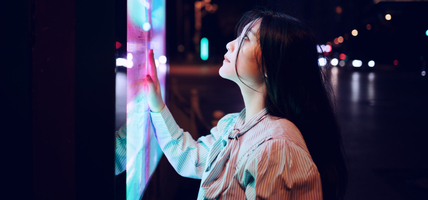 Young woman using touch screen on the street in Shanghai, China